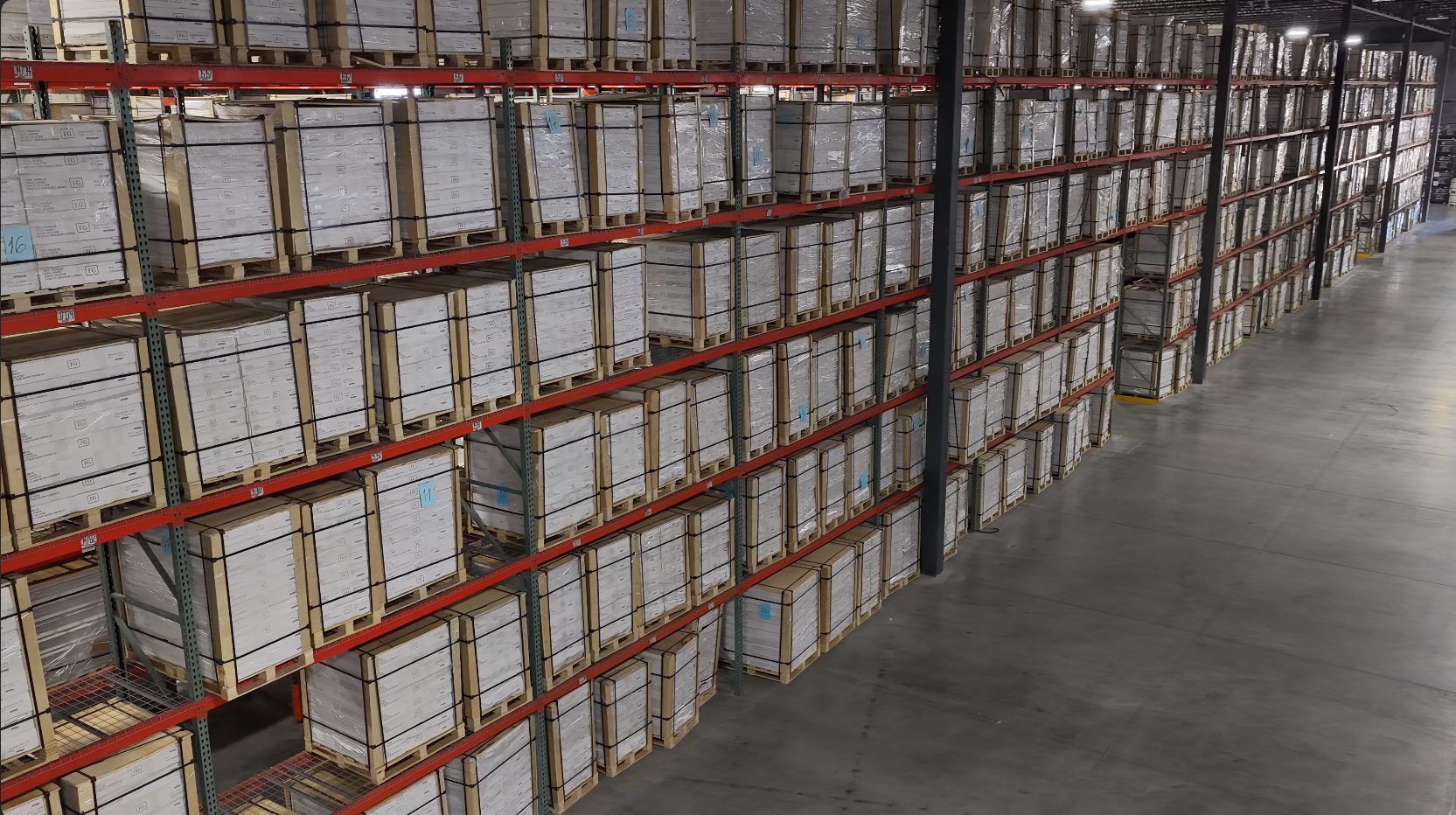Racking aisles stacked with palletized finished cabinets at the TaliWood Houston distribution hub